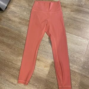 Slightly cropped pink Lululemon leggings.